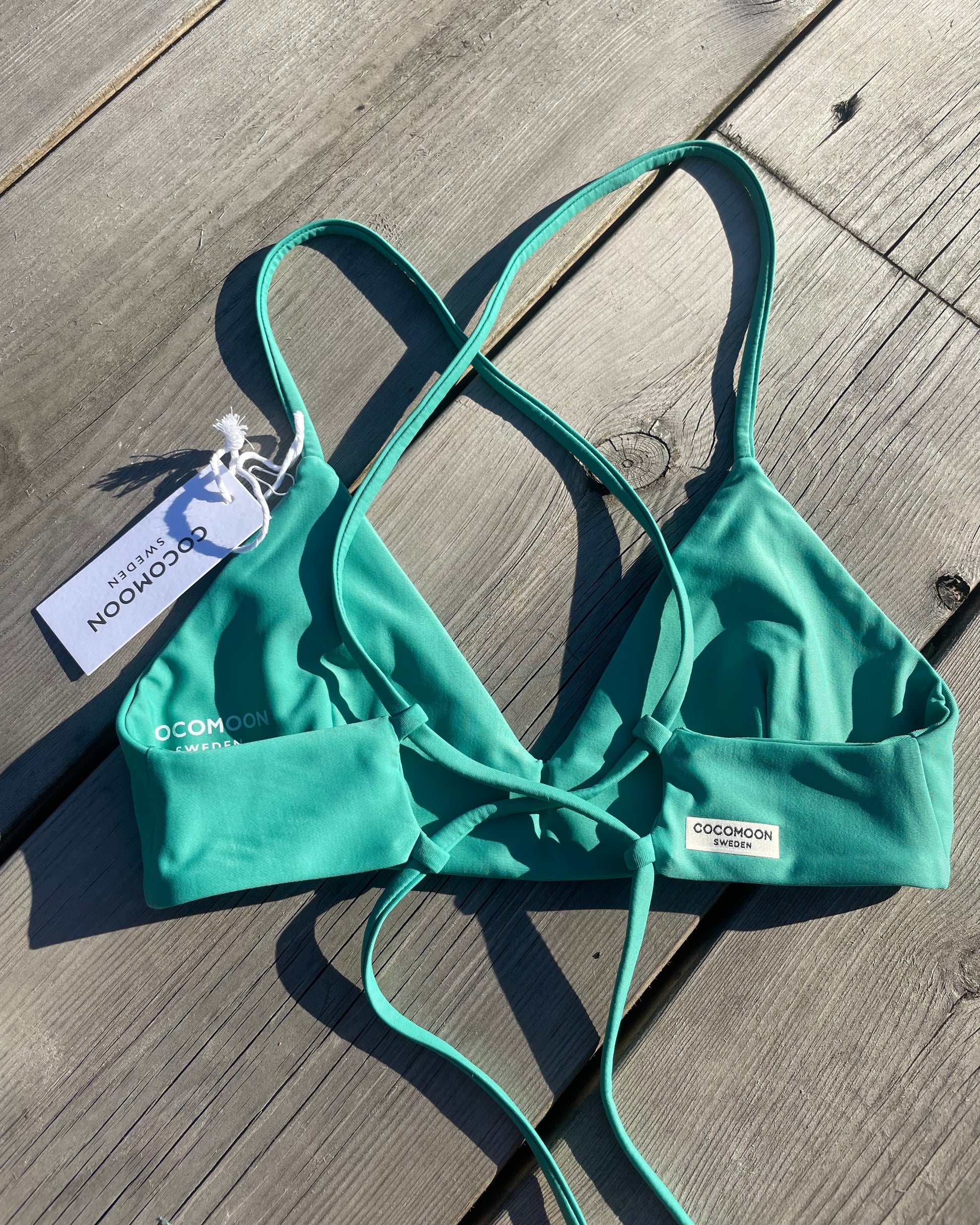 Grön bikinitopp från Cocomoon Sweden. En sportig och smickrande bikiniöverdel med justerbar snörning i ryggen för extra bra passform. Svenska badkläder och hållbara material.